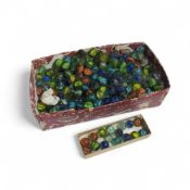A collection of glass marbles, largely with variou