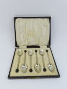 A cased set of enamelled coffee bean silver teaspo