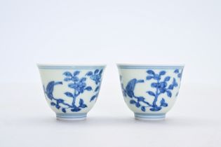 A pair of Chinese blue and white cups with birds among blossoming branches, Chenghua mark, 19th/20th