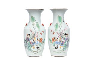 A pair of Chinese famille rose vases with a lady and children in a palace garden playing with a cat,