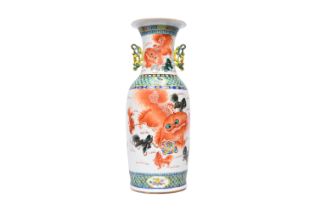 A Chinese famille rose and iron-red vase with a double design of an animated scene and Buddhist lion