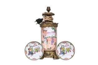A Chinese famille rose 'Mandarin' vase mounted as a lamp and a pair of famille rose saucers, 18th/20