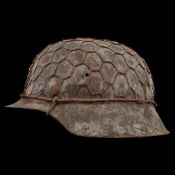 WWII Nazi German M42 Combat Helmet with metal mesh for attaching camouflage.