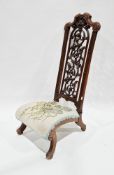 19th century walnut low chair, the high back with pierced scrolling foliate splat, woolwork