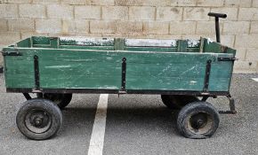 Green painted wooden pull-along cart, with hinged drop down sides, cast iron frame with pull handle,