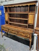 George III oak and walnut dresser, with shell and checker board string inlay, the moulded and shaped