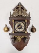 Dutch-style wall clock with brass pear-shaped weights, the pierced and decorated frieze marked 'Nu