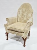Early 20th century camel back armchair in the Queen Anne manner, with cream monkey pattered