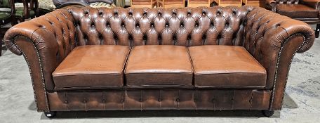 Office reception chesterfield style brown buttoned leather three seater sofa with brass studding, on