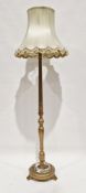 Giltwood standard lamp, the turned part fluted and part baluster column on a circular plinth base