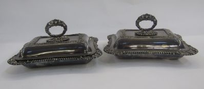 Pair of silver plated entree dishes, each rectangular, with ornate foliate bayonet handles, shell,