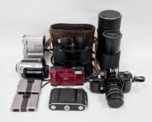 Collection of cameras including Asahi Pentax Spotmatic F camera, JVC GR-DVX digital video camera,