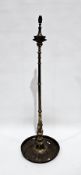 Middle Eastern brass standard oil lamp, the turned tapered column on a circular tray base, later