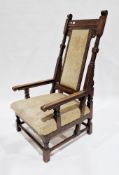 Arts and Crafts oak open armchair with dentil carved top rail, upholstered solid splat and stuff-