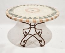 Modern circular conservatory table with marble and stone inlaid effect top, on a scrolling metal