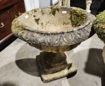 Pair of composite stone garden terrace urns of campana form, with moulded egg and dart rim, on a