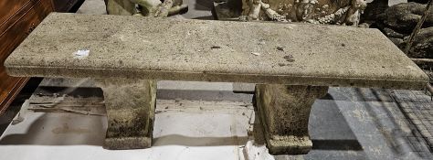 Composite stone garden bench, the rectangular top on two plinth support with moulded scroll