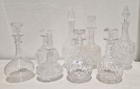 Group of eight cut-glass and etched decanters and stoppers, including: a Victorian globular decanter
