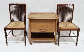 Mid-century oak sewing cabinet trolley, the hinged lid opening to fabric lined interior, with drawer