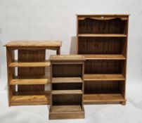 Three modern pine bookcases, the largest 135cm high x 76cm wide