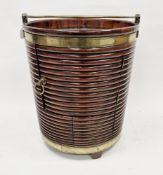 Mahogany peat bucket in the Irish George III manner, of ribbed and tapering form, brass bound with a