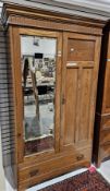 Late 19th / early 20th century oak wardrobe, the moulded cornice over a mirrored door and a panelled