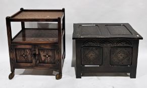 20th century oak tea trolley, two tiers with cupboard below, the carved doors with acorn handles, on