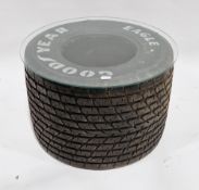 Coffee table formed from a Formula 1 racing car tyre and a circular glass top, 43cm high x 66cm