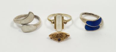 Two sterling silver and enamel cross-over rings, the ends set with enamel panels (one white, one