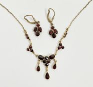 10k yellow gold and garnet link necklace, set with round, oval and drop pear-shaped garnets,