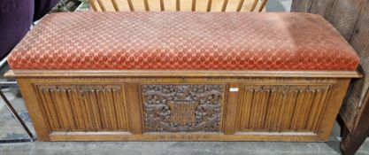 Early 20th century carved oak coffer with upholstered cushion top, the lock mechanism marked 'HSP&