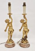 Pair of French-style gilt resin putti candlestick lamp bases, each modelled as a putto holding aloft