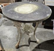 Circular marble top table, the ornate iron base with three legs cast with face masks, 71cm