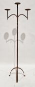 Hand forged floor standing iron three branch candle pricket, in the ecclesiastical gothic manner,