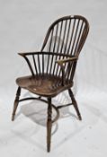 Elm seated and ash Windsor hoop and comb back elbow chair with saddle seat, on turned legs united by
