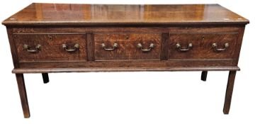 George III oak dresser base, the rectangular top with moulded edge above three cock-beaded frieze