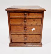 19th century stained pine table top collector's cabinet, the four graduated drawers with turned