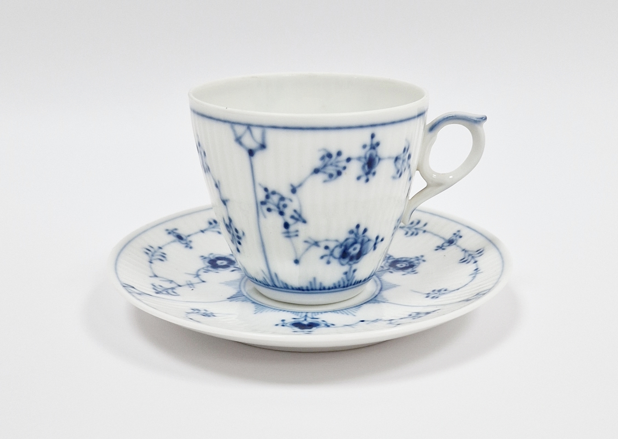 Royal Copenhagen blue and white lace-pattern teacup and saucer, printed blue and green marks,