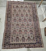 Eastern cream ground rug with allover hanging basket and stylised bird design, multiple geometric