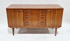 Mid-century retro tola wood sideboard comprising central bank of three drawers flanked by two