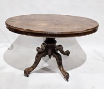 Victorian walnut loo table, the oval tilt top with moulded edge on a carved baluster support with