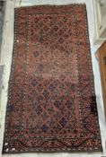 Eastern red ground rug with central floral pattern, single geometric border 180cm x 98cm