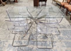 Contemporary dining room suite comprising a clear glass top dining table on a central chrome cross-