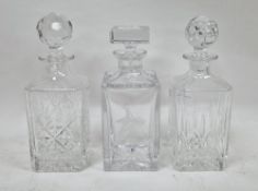 Three contemporary square-section glass whisky decanters and stoppers, comprising an example