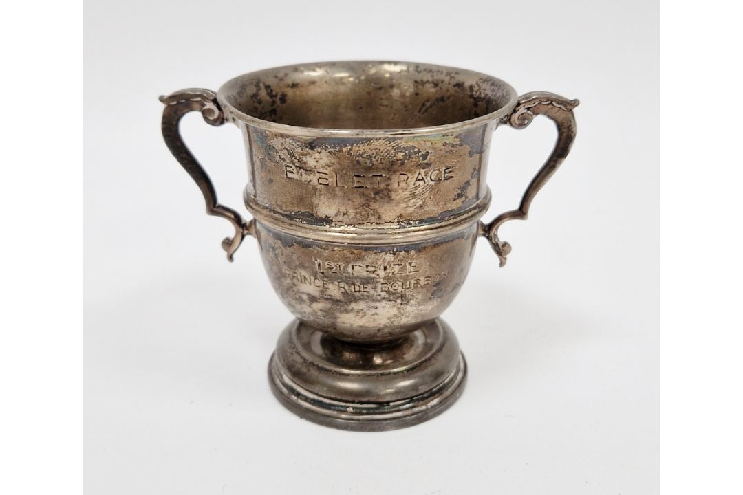 Silver small twin handled trophy, rubbed London hallmarks, marked to base Goldsmiths & Silversmiths,