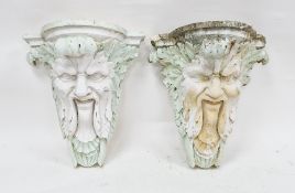 Pair of 20th century composite stone green-man mask garden wall brackets, the male bearded face