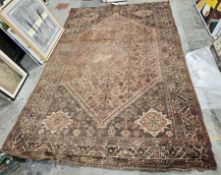 Eastern green ground carpet with central geometric medallion on floral and stylised animal pattern