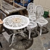 White painted metal garden table, two stools and two chairs featuring foliate design (5)