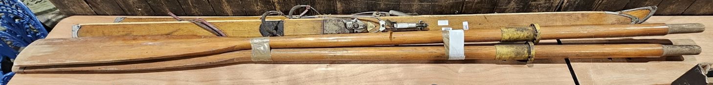 Pair of vintage wooden Hofer Sports (Montreux) skis and a pair of wooden oars, the first 194cm long