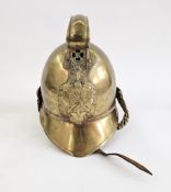 British Merryweather-style brass fireman's helmet with embossed decoration depicting fire
